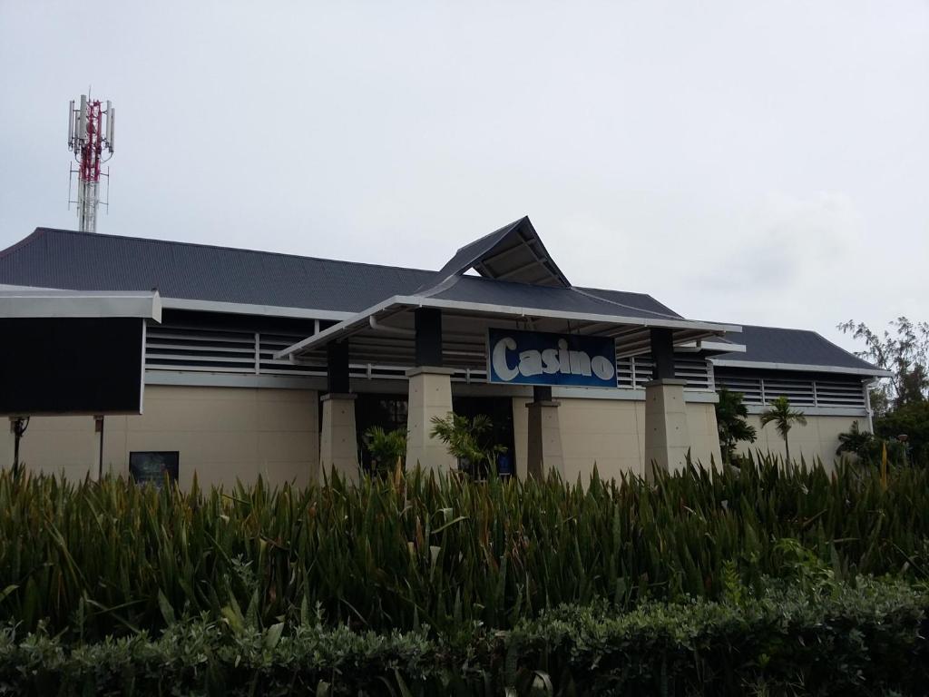 a building with a sign on the side of it at Appartement à la Résidence LA PLANTATION RESORT and SPA in Saint-François