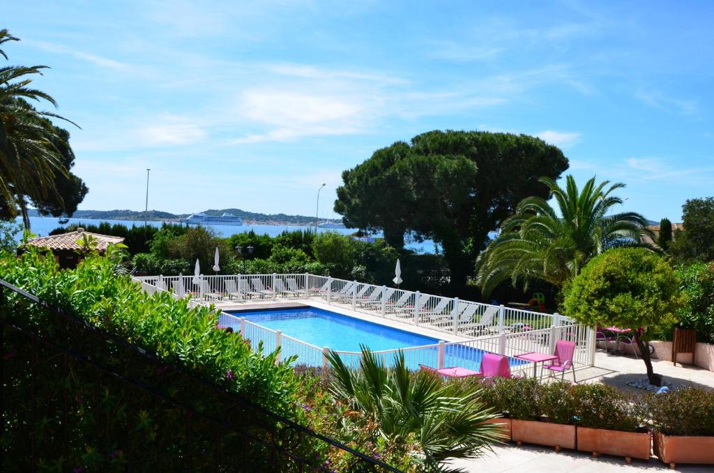 a swimming pool with a view of the water at Hotel Villa Des Anges in Grimaud