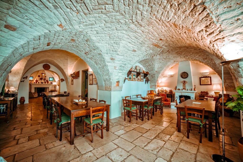 a large room with tables and chairs in a building at Masseria Il Frantoio in Ostuni