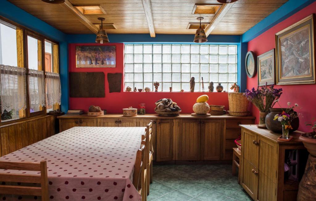 a dining room with a table and a window at Yanapanakusun Cusco in Cusco