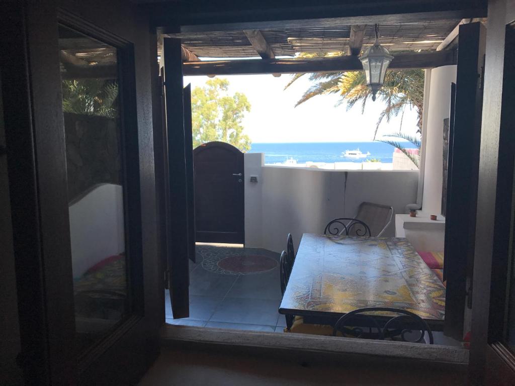 a room with a table and a view of the ocean at Casa Lorenzo in Stromboli