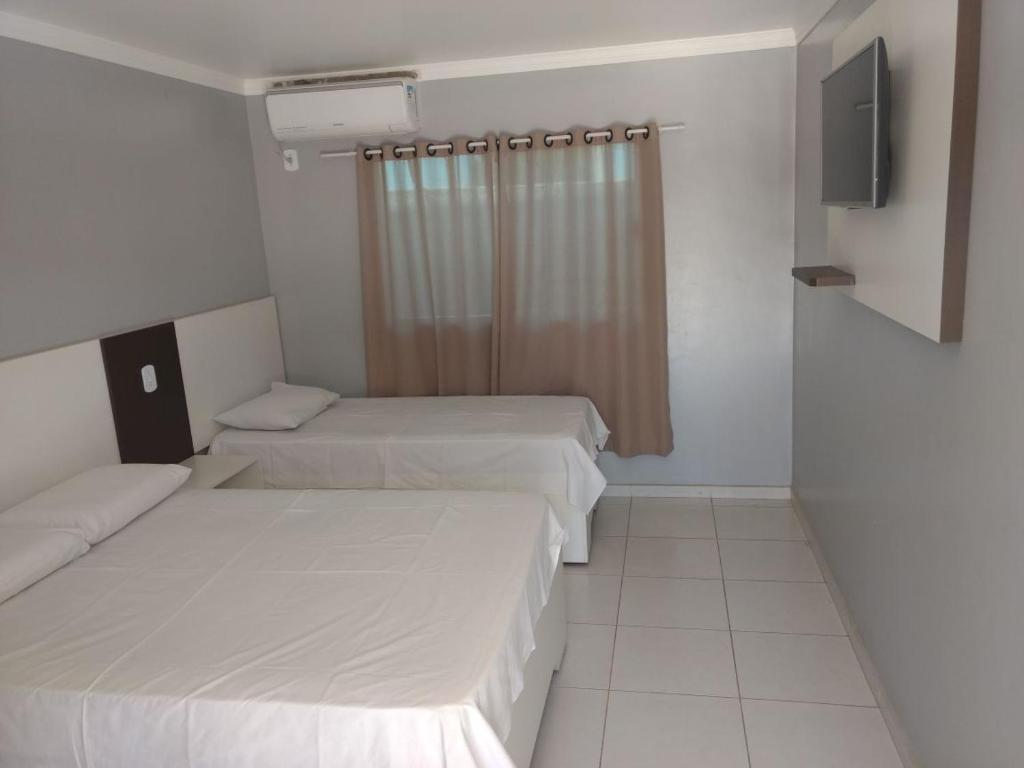 Postel nebo postele na pokoji v ubytování Hotel Serra do Rio