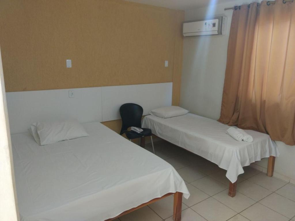 Postel nebo postele na pokoji v ubytování Hotel Serra do Rio