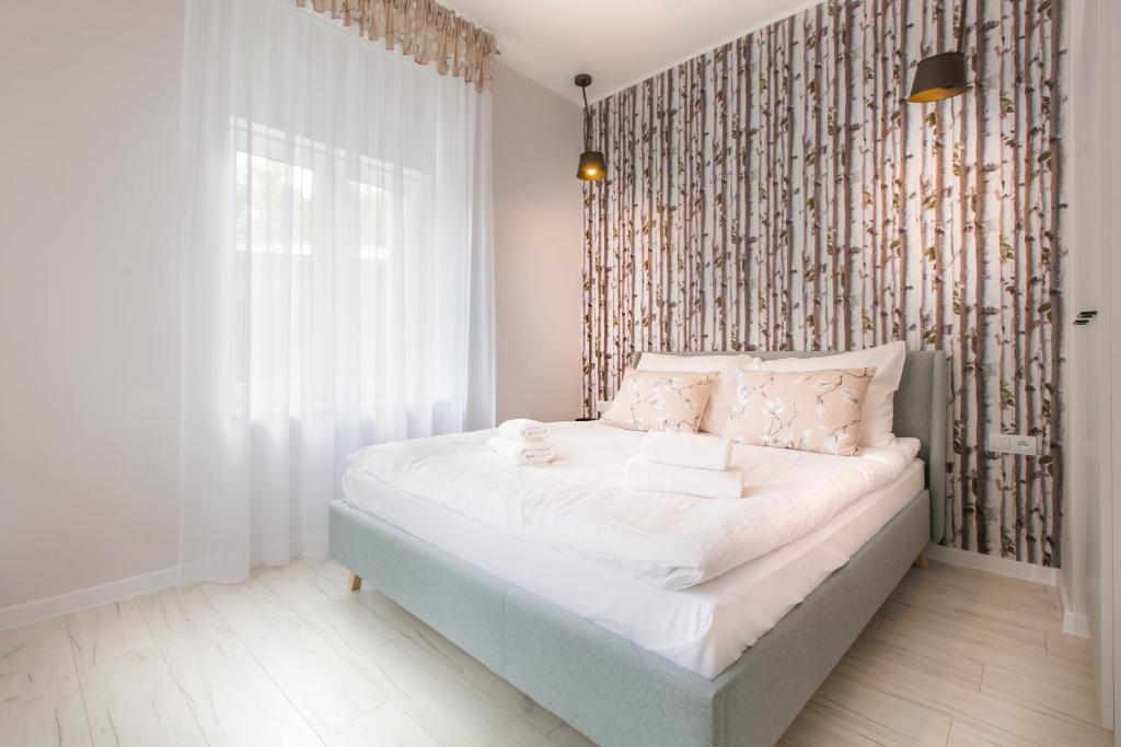 Postel nebo postele na pokoji v ubytování Apartamenty City.