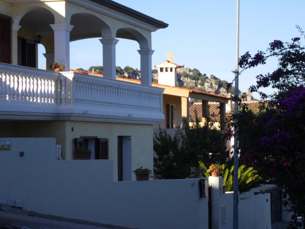 a white fence in front of a house at B&B La Collina in Posada