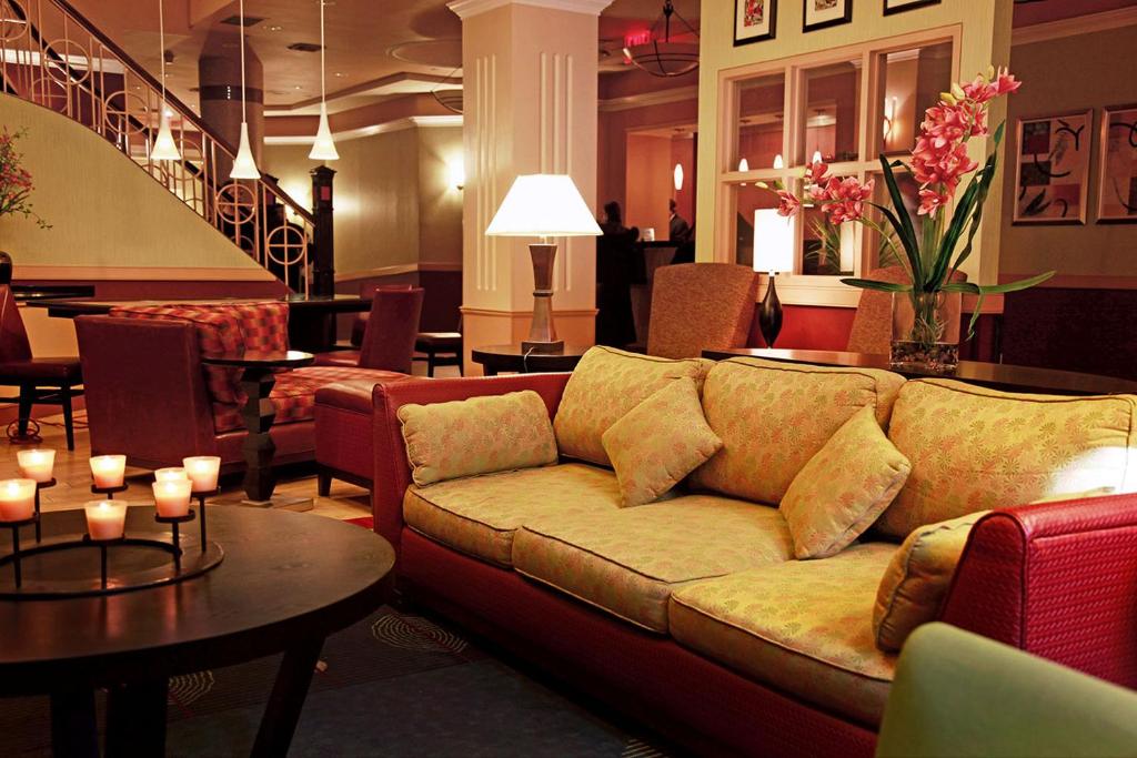 a living room filled with furniture and flowers at The Hotel at Times Square in New York