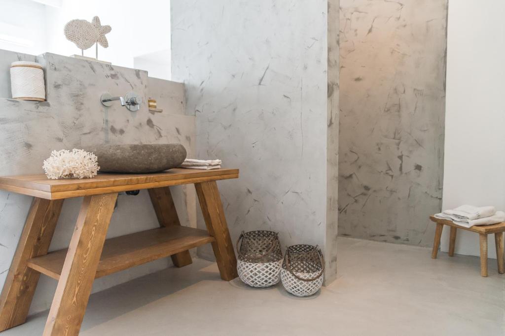 a bathroom with a wooden table and a sink at Aretousa Deluxe Downtown Apartment in Skala