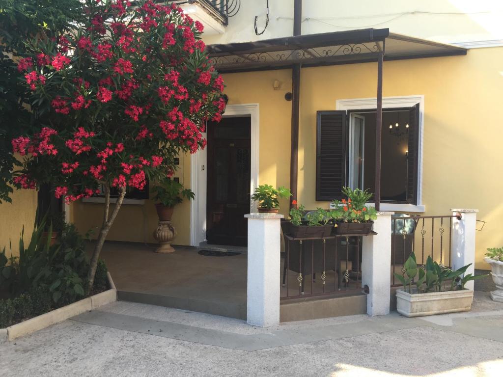 a house with flowers on the front porch at Rooms Tusculum in Opatija