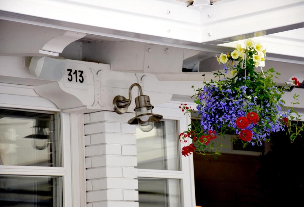 a door with a number and flowers on it at Hotel Ristorante Fortuna in Cavallino-Treporti