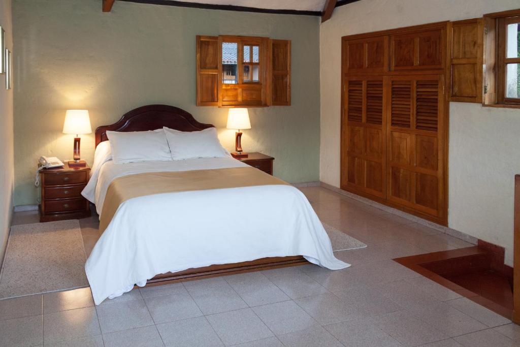 Postel nebo postele na pokoji v ubytování Hotel Campestre Los Arrayanes