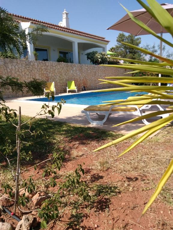 a swimming pool in the backyard of a house at Villa Casa do Monte in Silves