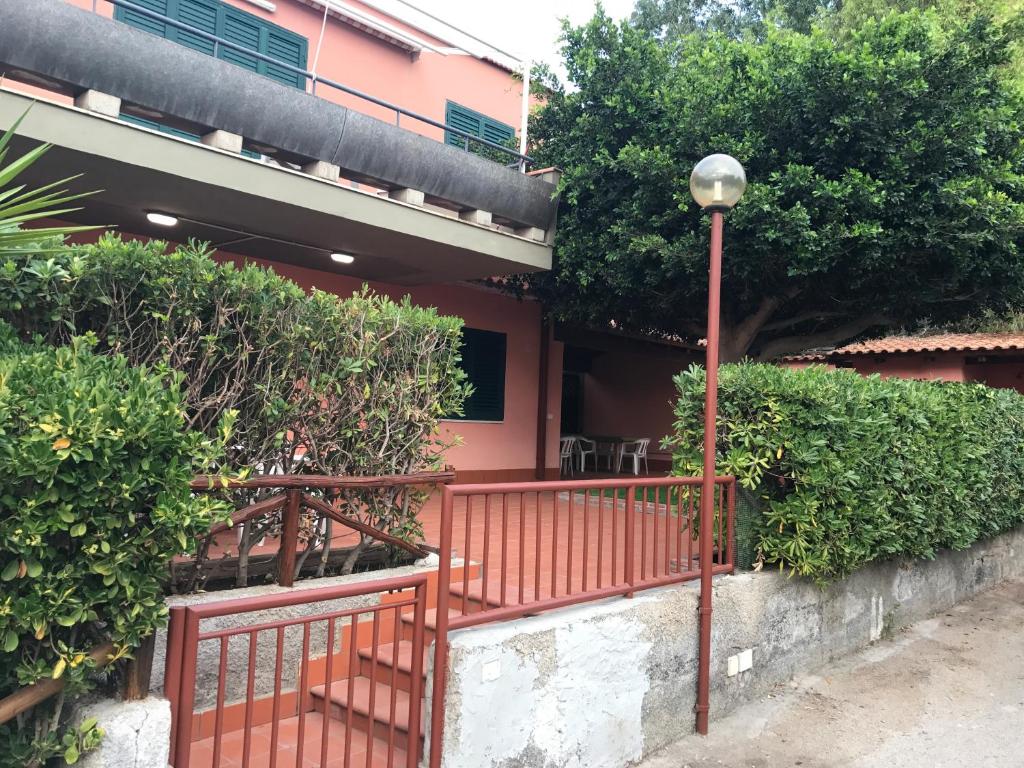 アニョーネ・バーニにあるVilla Mimosaの赤柵と街灯のある建物