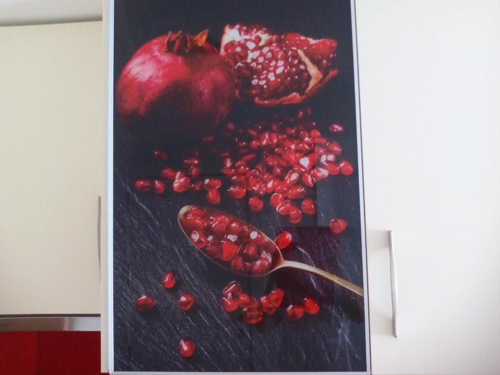 a painting of an apple and pomegranates on a table at New La Granada in Granada