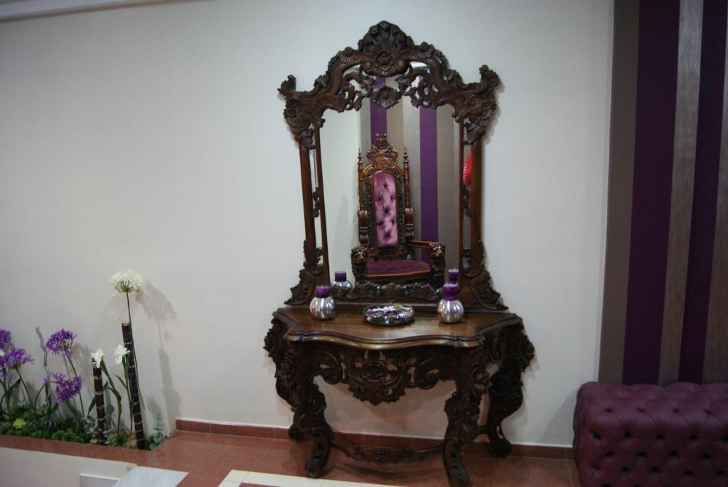 an ornate mirror sitting on a table in a room at Hotel Doña Luisa in San Luis de Sabinillas