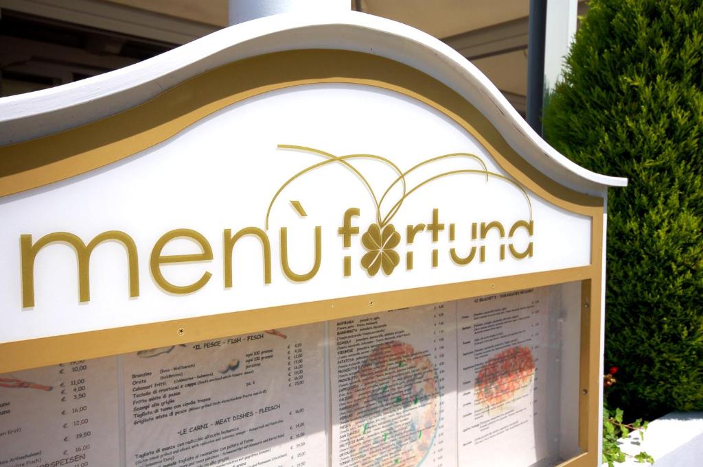 a sign for a moru fiumicino supermarket at Hotel Ristorante Fortuna in Cavallino-Treporti