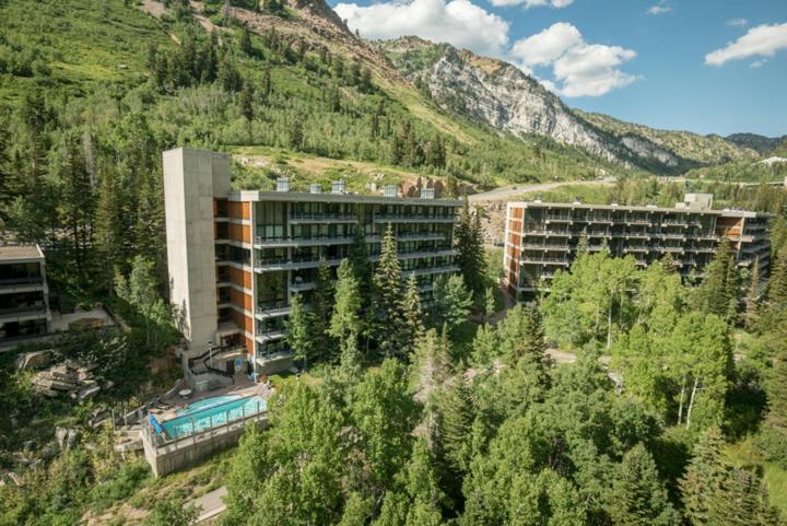 an aerial view of a building with trees and mountains at Inn at Snowbird in The Cliff Lodge