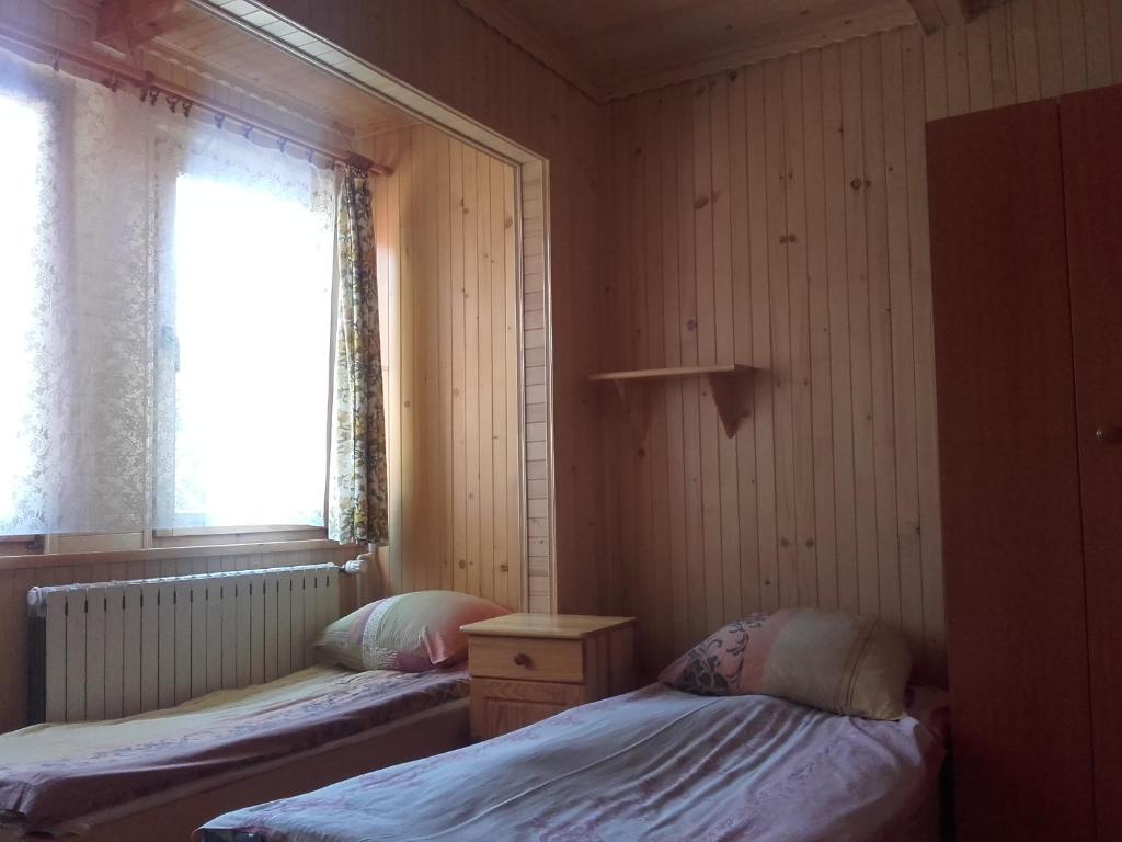 2 camas en una habitación pequeña con ventana en Willa u Kasi en Zakopane