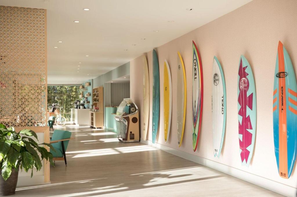 a row of surfboards on a wall in a room at Dream Inn Santa Cruz in Santa Cruz