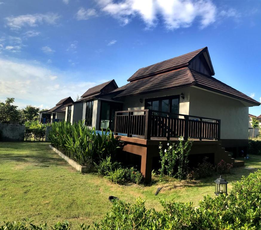 una casa con techo de gambrel en The Hip Resort @ Khao Lak, en Bang Sak