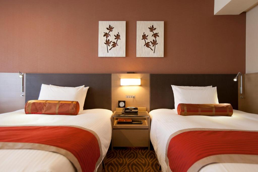 Postel nebo postele na pokoji v ubytování Hotel Sardonyx Tokyo
