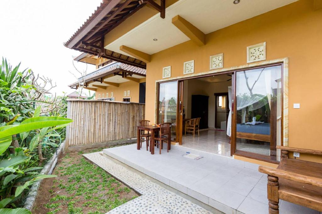 a patio of a house with a table and chairs at Ubud Batik Villa in Ubud