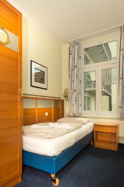 Postel nebo postele na pokoji v ubytování Hiddenseer Hotel