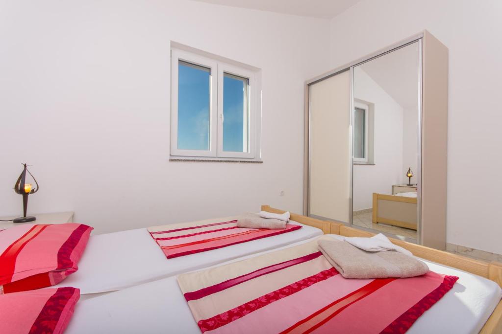 Posteľ alebo postele v izbe v ubytovaní Apartments Jaman Ivan