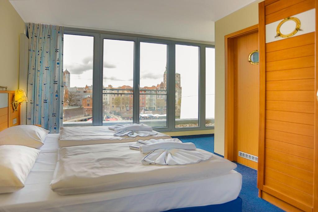 Postel nebo postele na pokoji v ubytování Hiddenseer Hotel