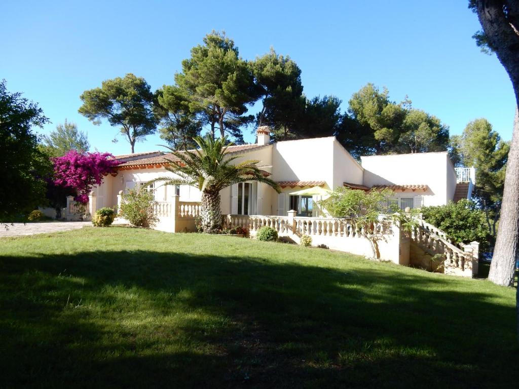 a house with a fence and a yard at Finca En Sueno de Son Jaumell in Cala Ratjada