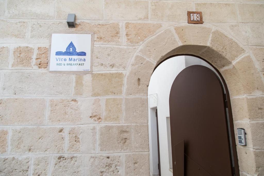 an entrance to a building with a sign on the wall at Vico Marina in Laterza