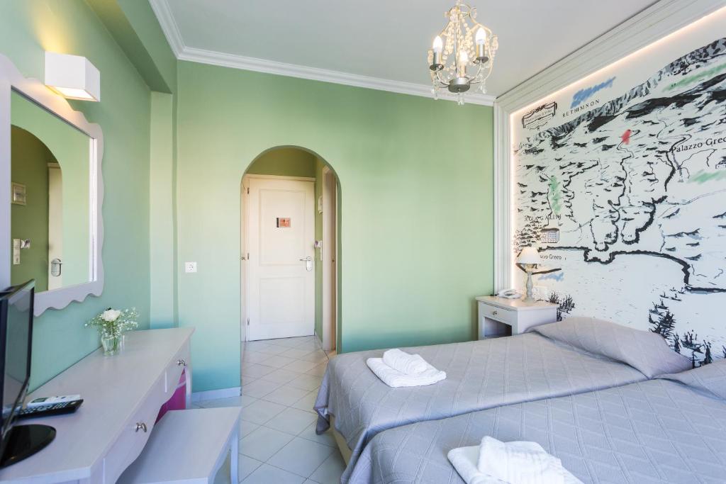 Postel nebo postele na pokoji v ubytování Palazzo Greco