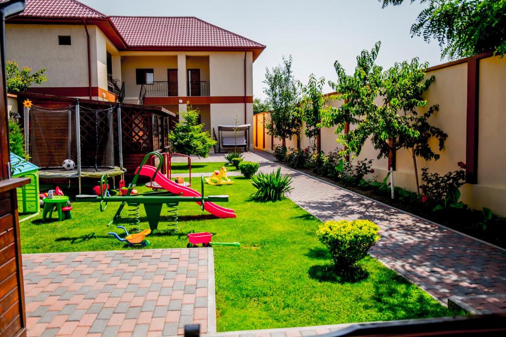 a backyard with a playground with a play table at Casa Andu in 2 Mai