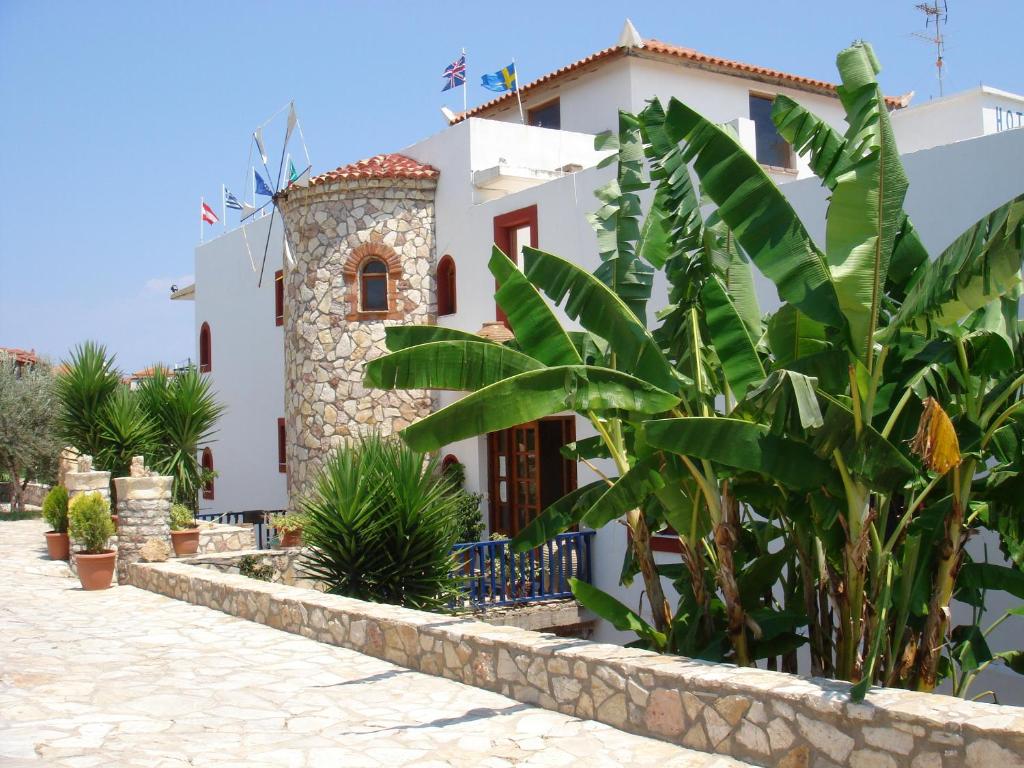 a house with a bunch of plants in front of it at ZagaMilos Hotel in Koroni