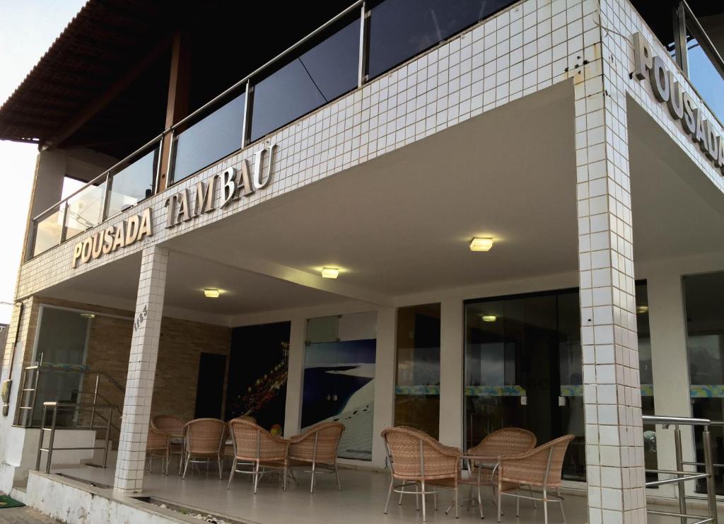 a group of chairs sitting outside of a building at Pousada Tambaú in São Luís