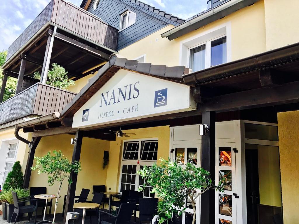 a restaurant with a sign for a cafe at Nanis Hotel & Appartements in Steinhude