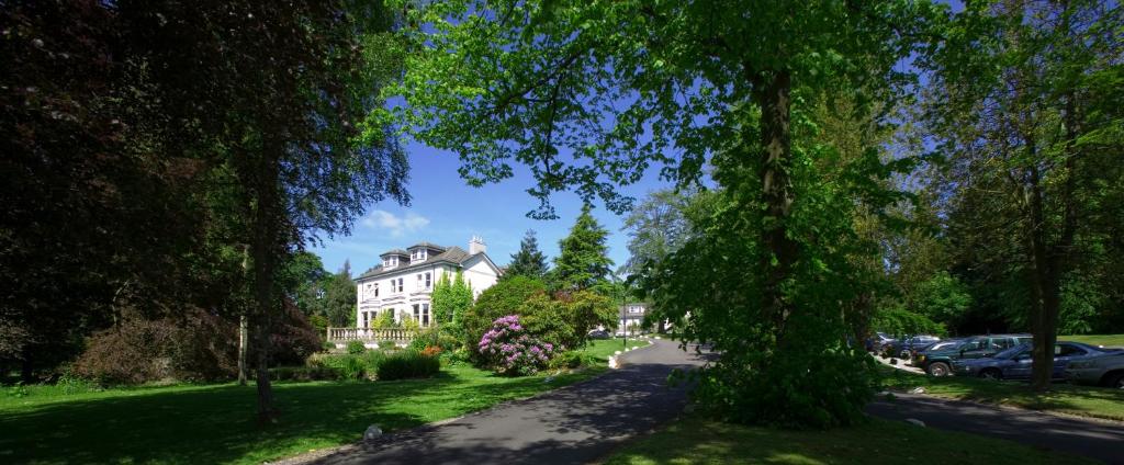 a house in the middle of a street with trees at The Marcliffe Hotel and Spa in Aberdeen