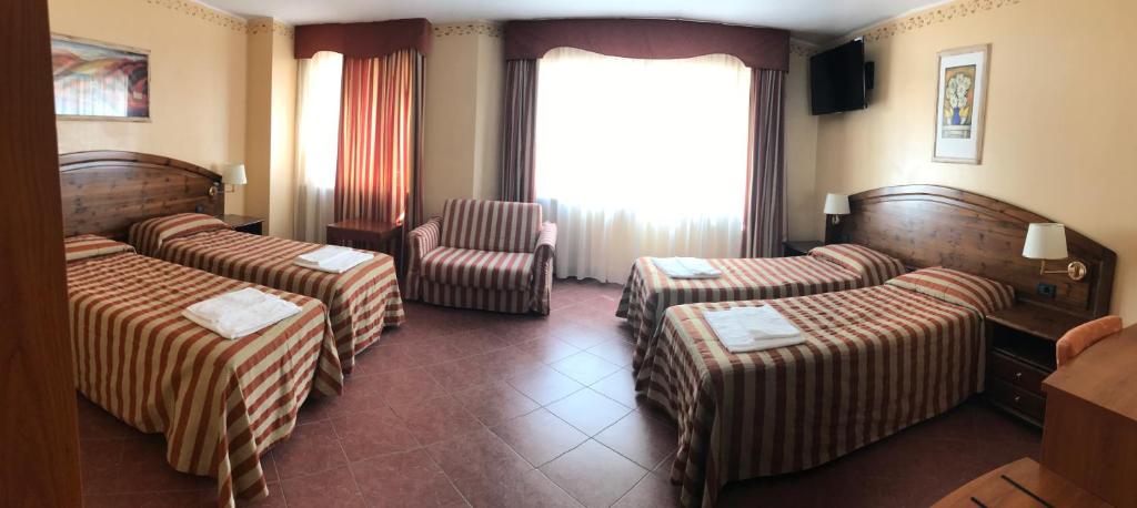 Postel nebo postele na pokoji v ubytování Hotel Relais Des Alpes
