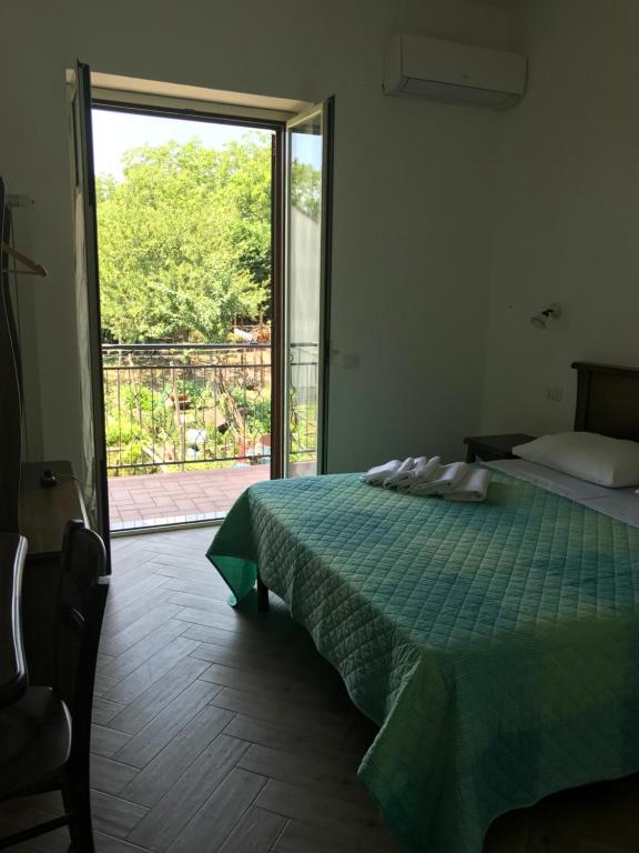 a bedroom with a bed and a sliding glass door at Luna D'Agerola in Agerola