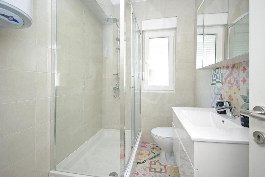 a white bathroom with a shower and a toilet at "NM" Luxury apartments in Split