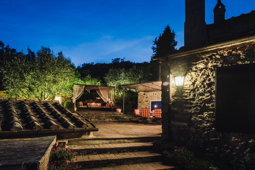a garden with a tent and a stone building at Borgo degli Ulivi in Porto Ercole