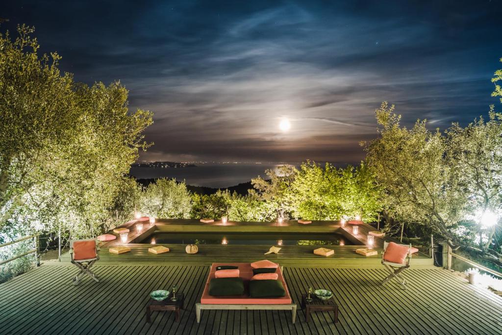 a backyard with a pool at night at Borgo degli Ulivi in Porto Ercole