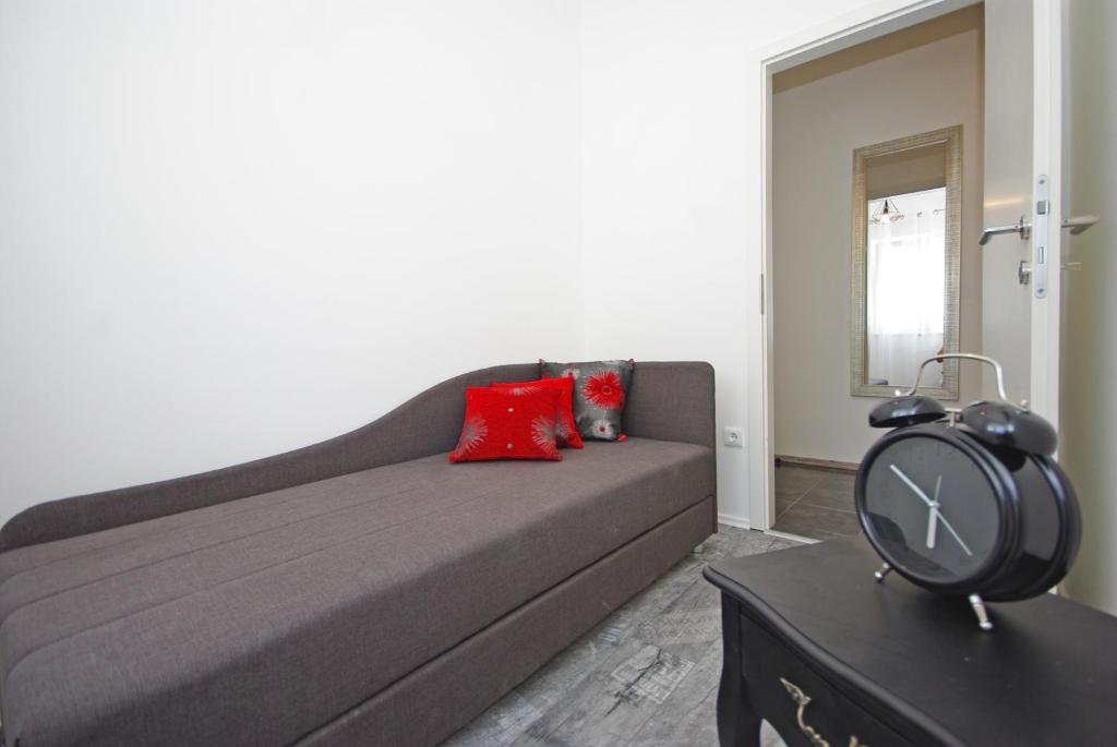 a living room with a couch and a clock on a table at "NM" Luxury apartments in Split