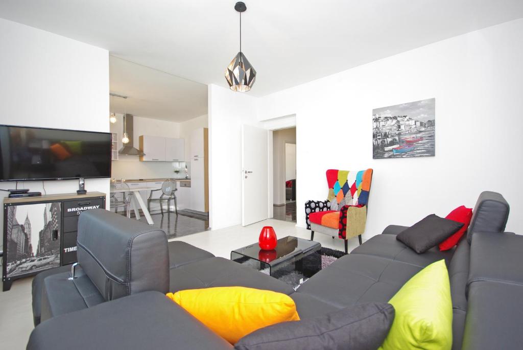 a living room with a couch and a tv at "NM" Luxury apartments in Split