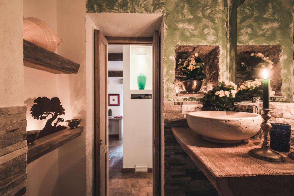 a bathroom with a bowl sink on a counter at Borgo degli Ulivi in Porto Ercole