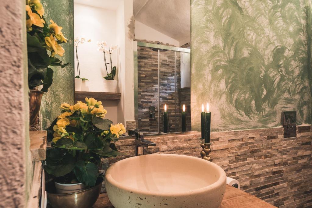 a bathroom with a bath tub and a mirror at Borgo degli Ulivi in Porto Ercole