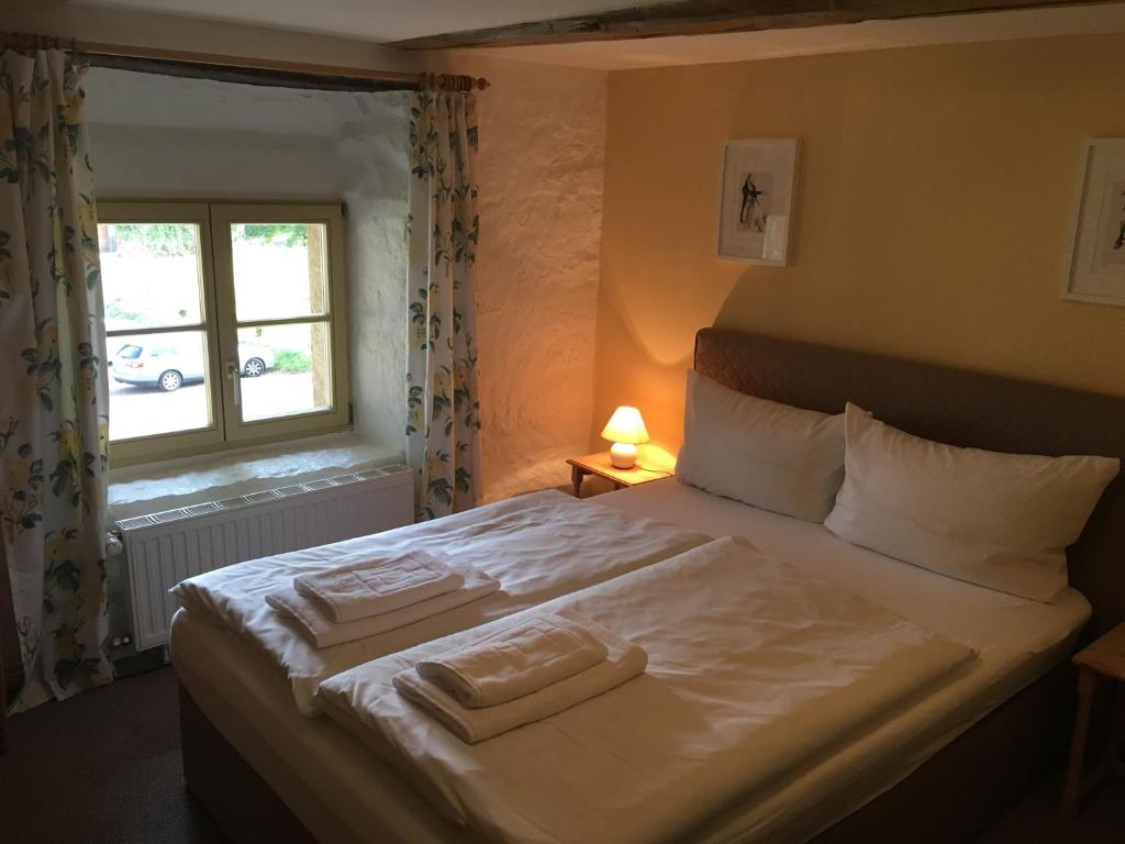 a bedroom with a bed with two towels on it at Kloster Hedersleben in Hedersleben