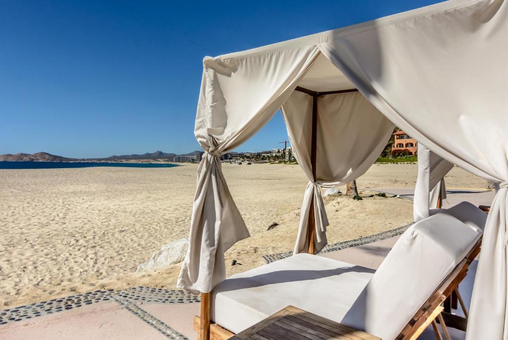 a couple of chairs and a canopy on a beach at Condominios Brisa - Ocean Front in Cabo San Lucas