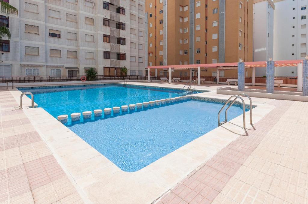 a large swimming pool in the middle of a building at Navegante in Gandía