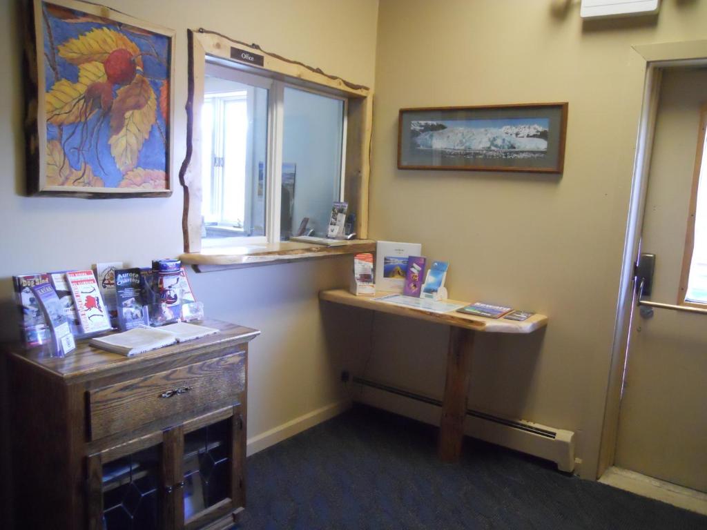 a room with a mirror and a desk and a window at A Swan Nest Inn in Seward