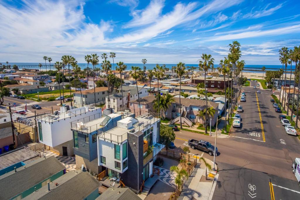 an aerial view of a city with palm trees and the ocean at Modern Beach Home Steps To The Sand in San Diego